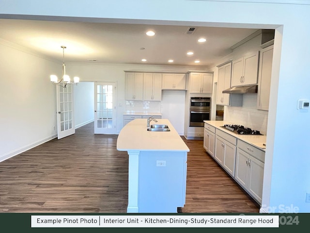 kitchen with an island with sink, white cabinetry, french doors, and sink