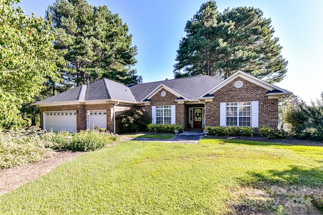 ranch-style house featuring a front lawn and a garage