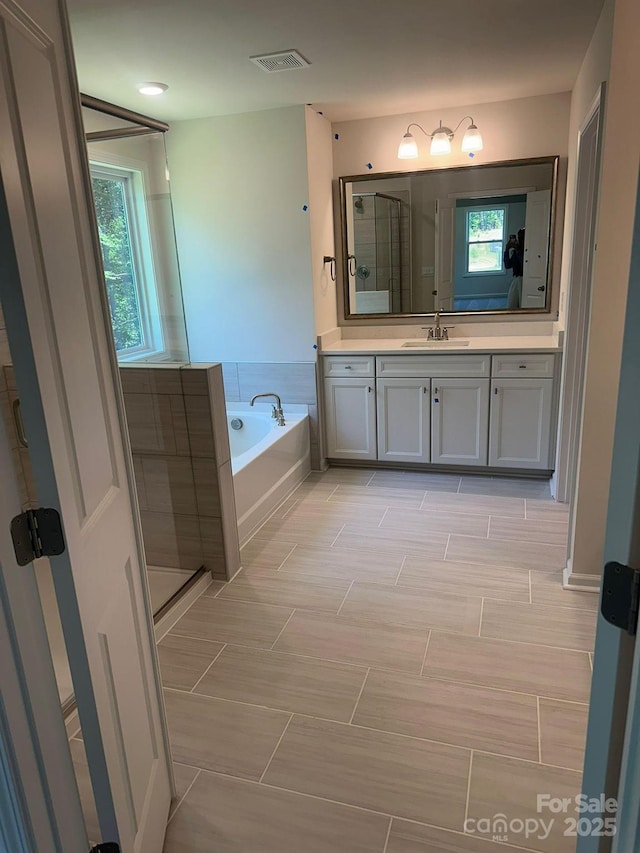 bathroom with vanity and plus walk in shower