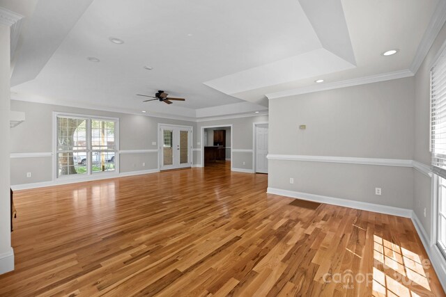 unfurnished living room featuring ornamental molding, light hardwood / wood-style flooring, and ceiling fan