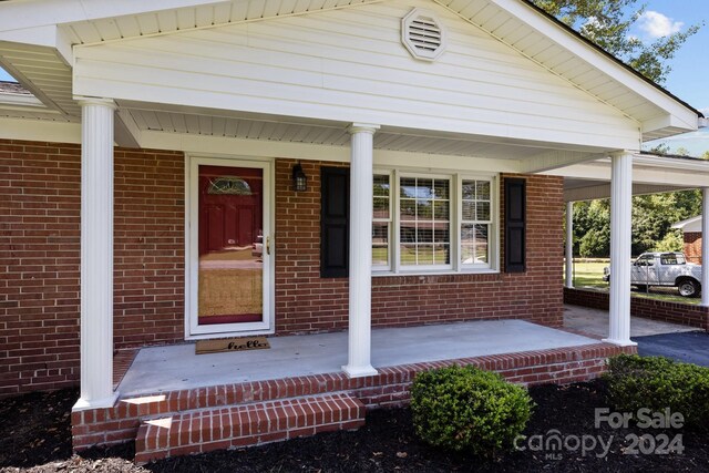 view of exterior entry featuring a porch