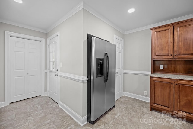 kitchen with stainless steel fridge, crown molding, and light tile patterned flooring