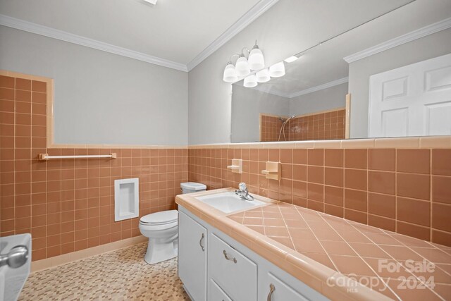 bathroom with tile patterned flooring, backsplash, toilet, tile walls, and vanity