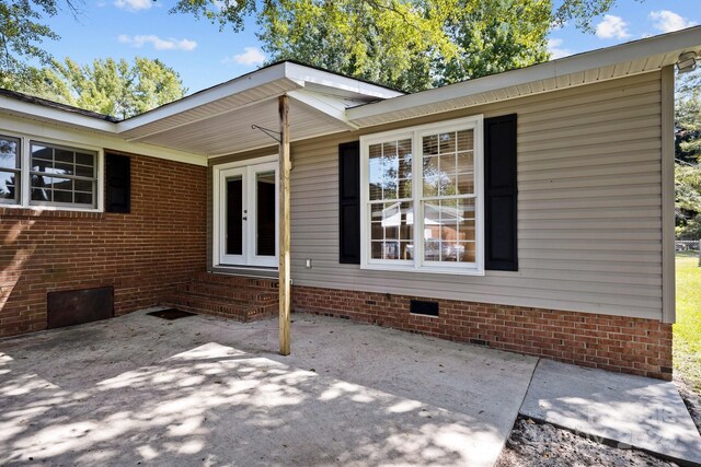 view of side of home with a patio