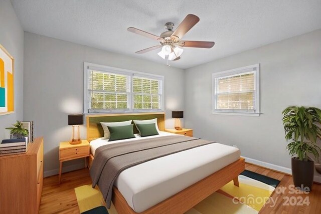 bedroom with ceiling fan and light hardwood / wood-style floors