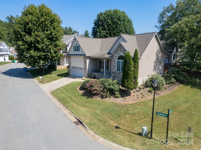 view of front facade with a front yard and a garage