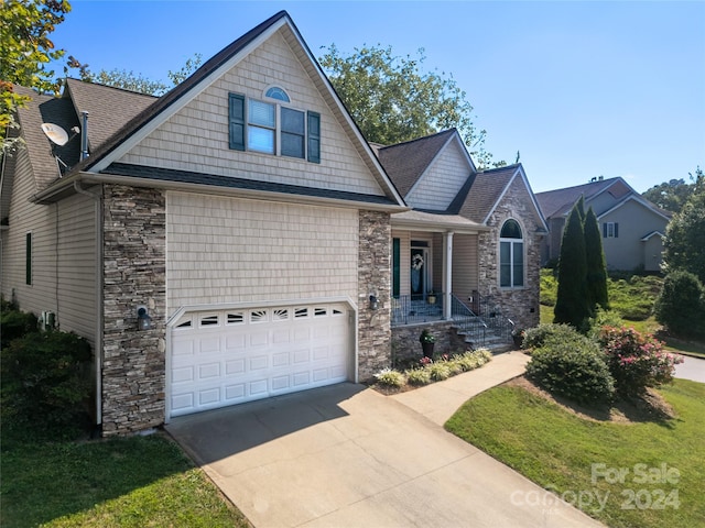 view of front of home featuring a garage, stone siding, roof with shingles, and concrete driveway