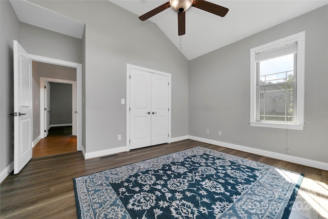 bedroom featuring lofted ceiling, baseboards, and wood finished floors