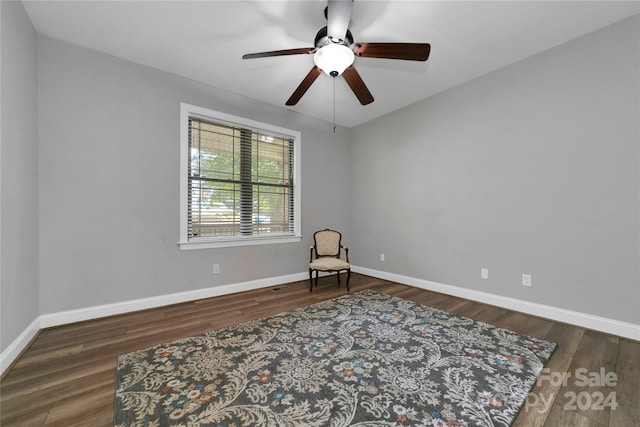 living area with ceiling fan, wood finished floors, and baseboards