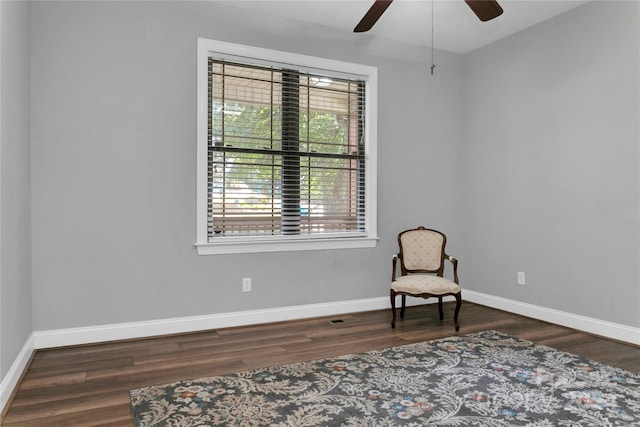 sitting room featuring ceiling fan, wood finished floors, visible vents, and baseboards