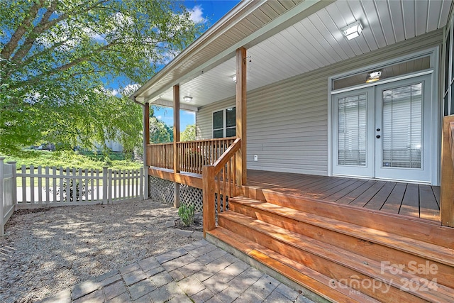 wooden terrace with french doors and fence