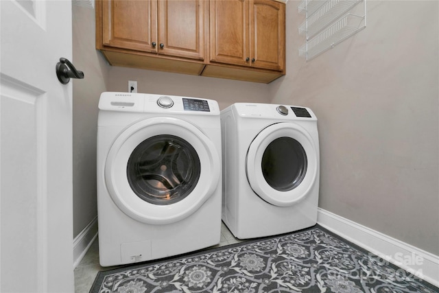 clothes washing area featuring cabinet space, light tile patterned flooring, baseboards, and independent washer and dryer