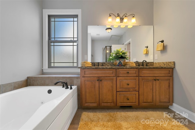 full bath with double vanity, a sink, a bath, and tile patterned floors