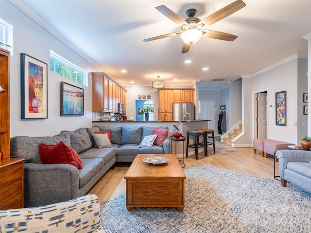 living room with ceiling fan, light hardwood / wood-style flooring, and ornamental molding