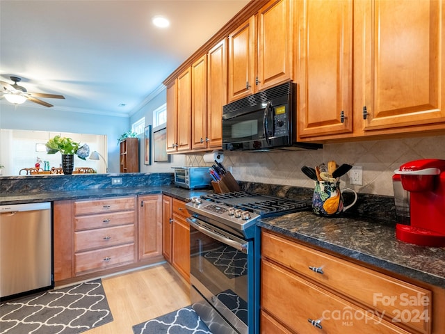 kitchen with ceiling fan, light hardwood / wood-style flooring, backsplash, appliances with stainless steel finishes, and crown molding