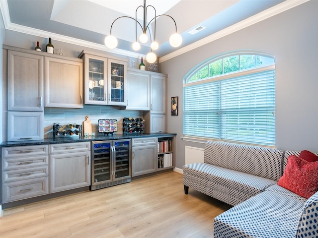 bar featuring tasteful backsplash, crown molding, light hardwood / wood-style floors, and wine cooler