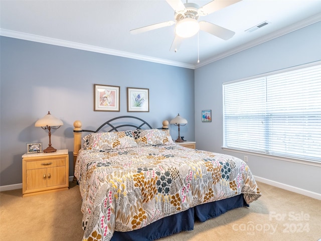 carpeted bedroom with ceiling fan and crown molding