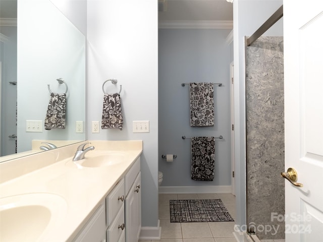 bathroom with dual vanity, crown molding, toilet, and tile patterned flooring