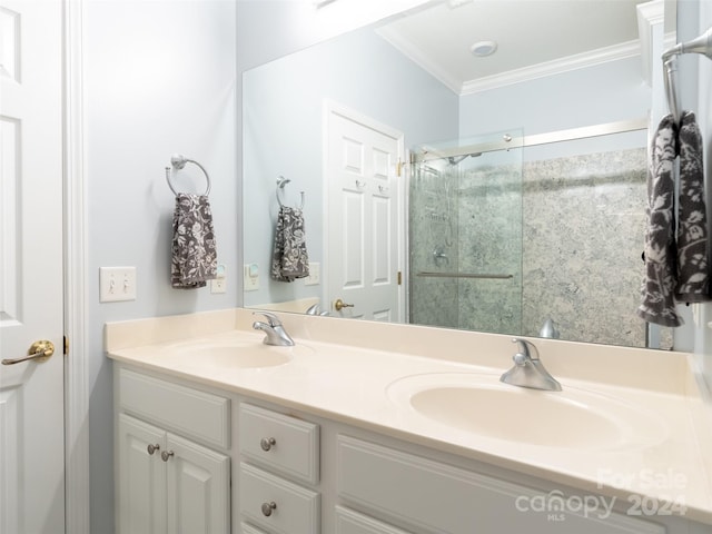 bathroom featuring double sink vanity and crown molding