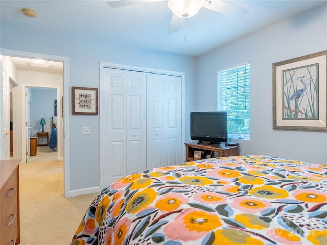 carpeted bedroom with ceiling fan and a closet