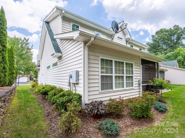 view of property exterior with a lawn