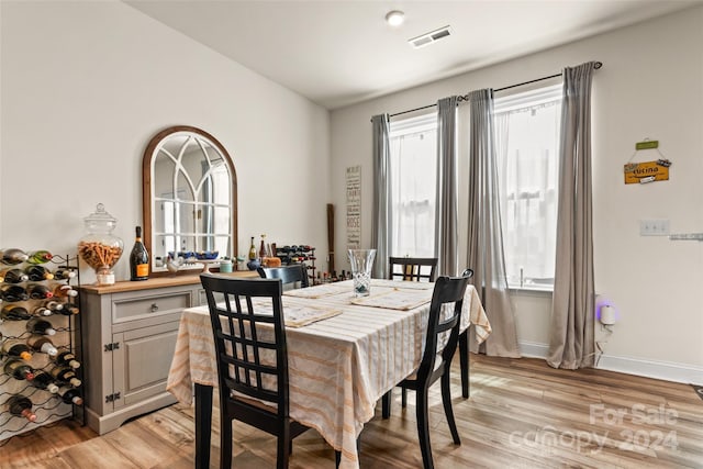 dining area featuring visible vents, plenty of natural light, and light wood-type flooring