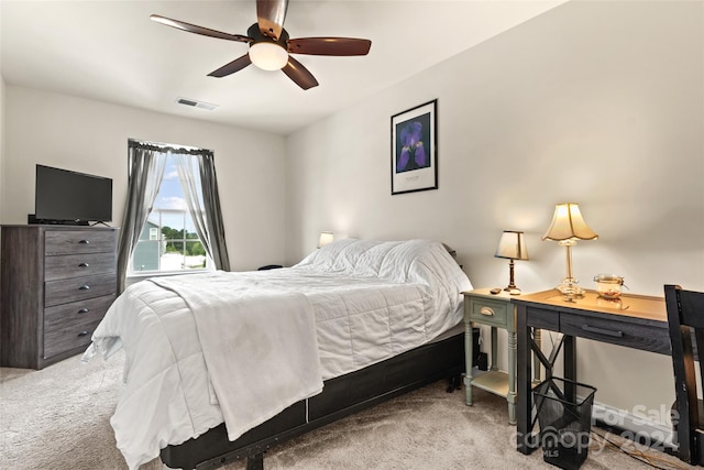 bedroom with ceiling fan and light carpet