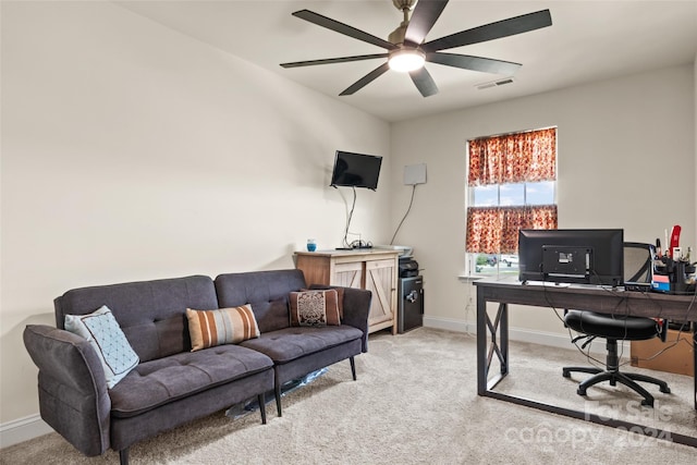 office space with light colored carpet, a ceiling fan, baseboards, and visible vents