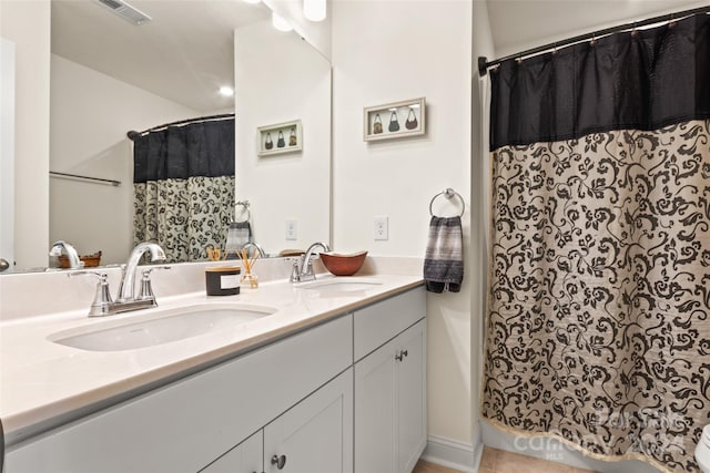 full bath featuring double vanity, a shower with curtain, visible vents, and a sink
