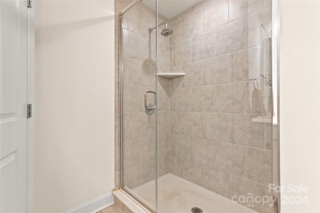 bathroom with a shower with shower door