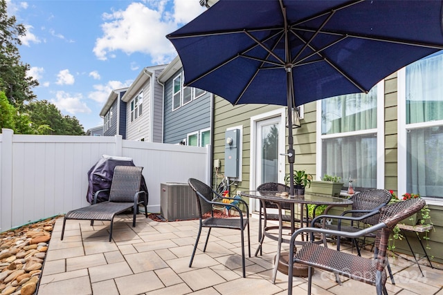 view of patio / terrace featuring fence and central air condition unit