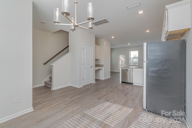 kitchen with white cabinetry, light hardwood / wood-style floors, and stainless steel appliances