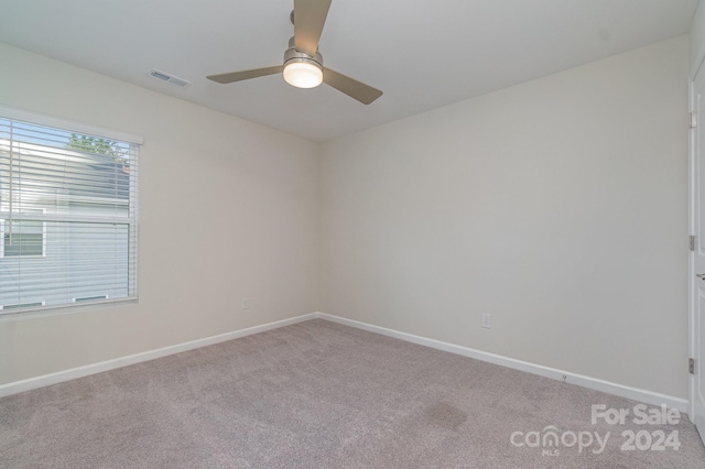 spare room featuring ceiling fan and carpet