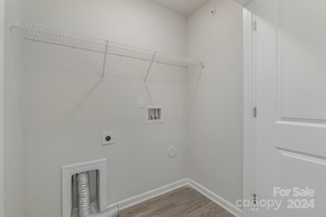 laundry area featuring electric dryer hookup, hookup for a washing machine, hardwood / wood-style floors, and gas dryer hookup