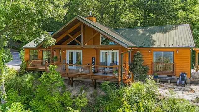 rear view of house featuring a patio area and a wooden deck