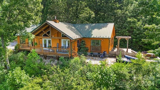 rear view of house featuring a deck and a patio