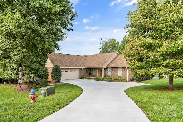 view of front of property with a garage and a front lawn