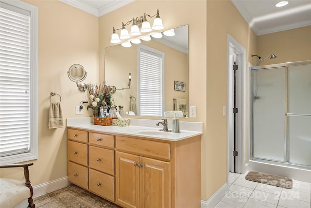 bathroom with crown molding, tile patterned floors, a shower with door, and vanity