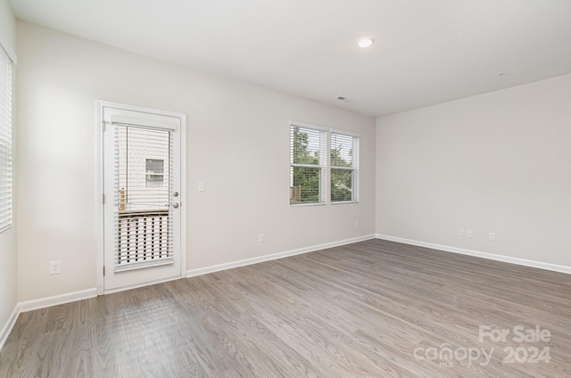 spare room with hardwood / wood-style floors