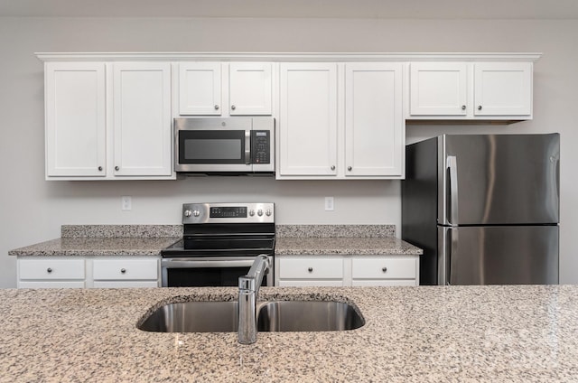 kitchen with sink, white cabinets, and stainless steel appliances