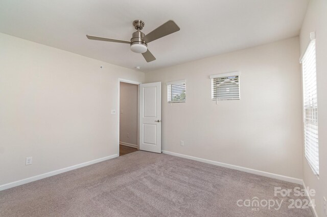 carpeted empty room with ceiling fan