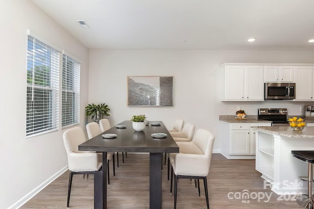 dining space featuring hardwood / wood-style flooring