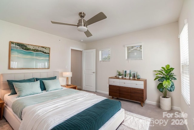 bedroom with ceiling fan and light colored carpet