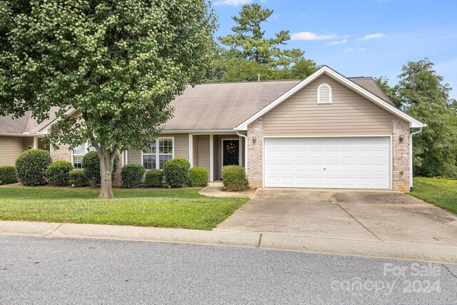 single story home with a garage and a front yard