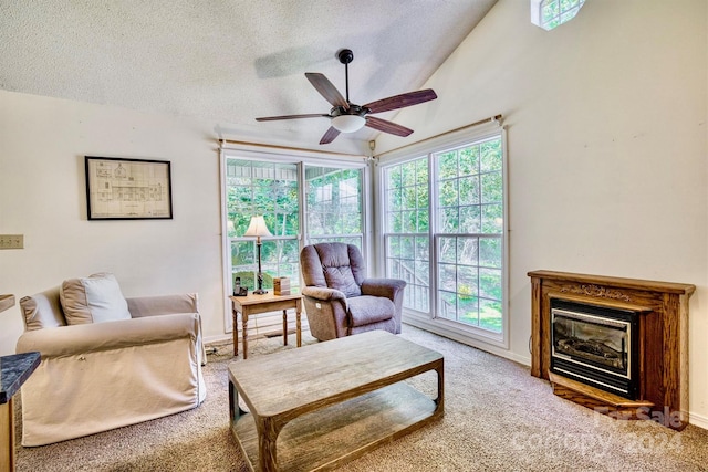 living room with ceiling fan, carpet floors, plenty of natural light, and a textured ceiling