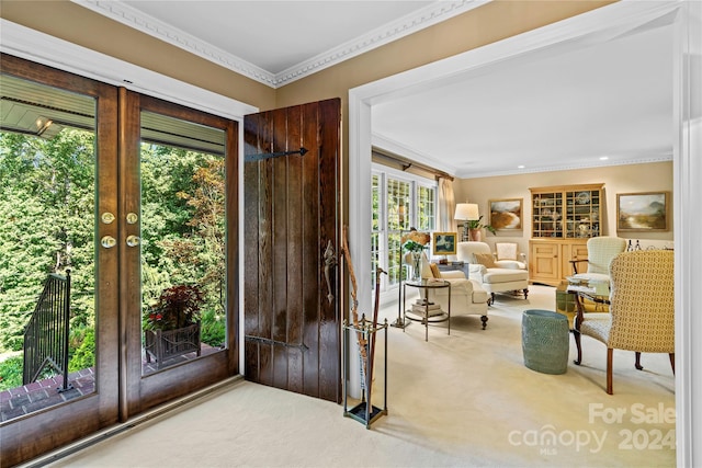 doorway featuring carpet flooring and ornamental molding