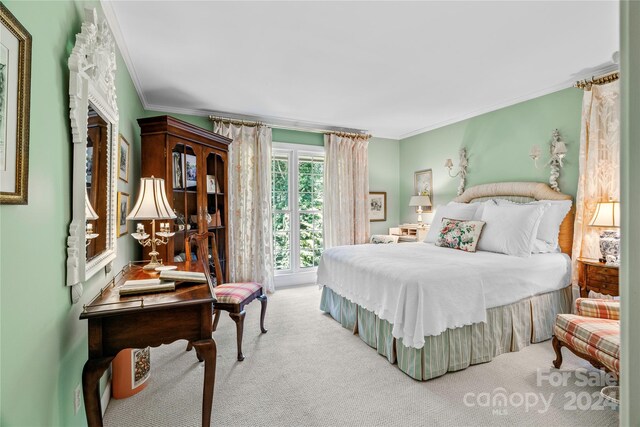 bedroom with light carpet and ornamental molding