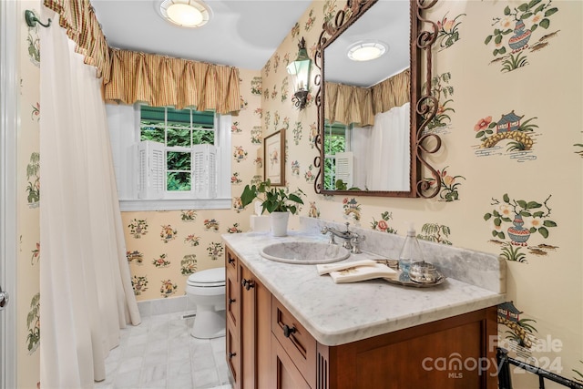 bathroom featuring tile patterned floors, toilet, and vanity