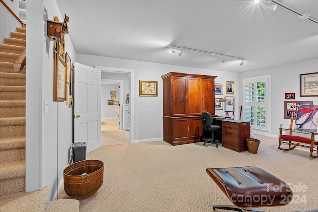 carpeted office featuring rail lighting