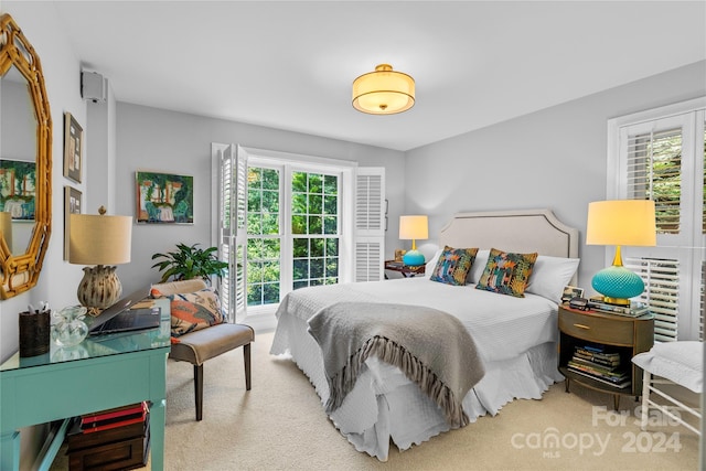 bedroom featuring light colored carpet